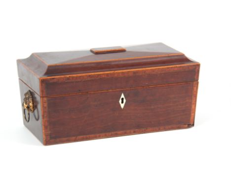 A GEORGIAN MAHOGANY SARCOPHAGUS SHAPED TEA CADDY with kingwood crossbanding and boxwood stringing having gilt lion mask handl