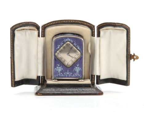 AN EARLY 20th CENTURY MINIATURE SILVER ENAMEL BOUDOIR CLOCK having a purple enamel on engine-turned silver case with swag wor