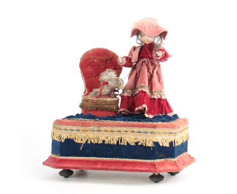 AN EARLY 20TH CENTURY MUSICAL AUTOMATON OF A GIRL PLAYING WITH A CAT the girl having a bisque porcelain head labelled on the 