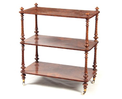 A VICTORIAN BURR WALNUT THREE TIER WHATNOT with rounded corners supported by twisted turned columns and turned bun feet with 