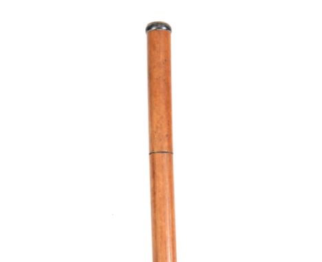 A 19TH CENTURY MALACCA SWORD STICK with tapering cane and pressed brass coat of arms, having a trifold blade 88cm overall. 