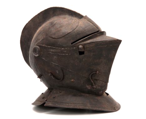 A CLOSE HELMET with a one-piece skull and comb, and hinged visor 31cm high