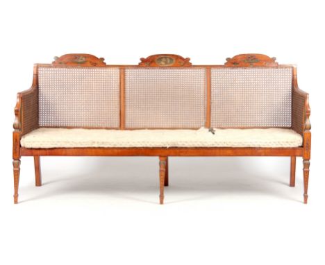 A 19TH CENTURY ADAM STYLE PAINTED SATINWOOD BERGERE THREE SEATER SETTEE with painted floral urns - button upholstered horseha