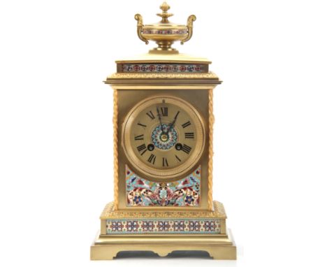 A LATE 19TH CENTURY FRENCH LACQUERED BRASS AND CHAMPLEVE ENAMEL MANTEL CLOCK with stepped leaf edged base and panelled front 