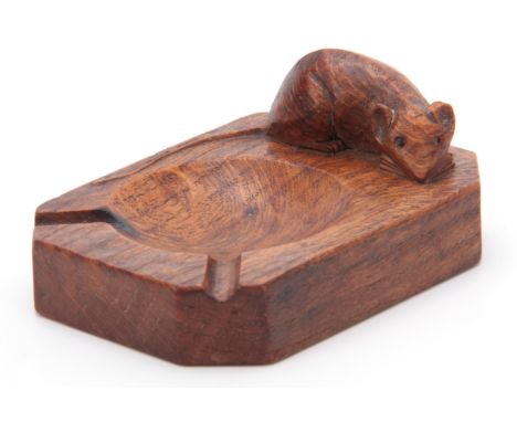 A ROBERT MOUSEMAN THOMPSON OAK ASHTRAY of clipped and rounded rectangular form with carved mouse trademark 10cms by 7cms 