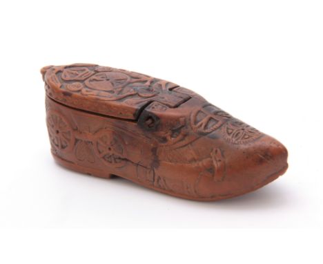 AN EARLY 19TH CENTURY CARVED BOXWOOD FOLK ART SNUFF BOX IN THE SHAPE OF A SHOE decorated with figures and animals, having a h