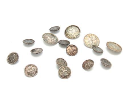 A SET OF LATE 19th CENTURY SILVER BUTTONS having four large buttons, 34mm diameter, and twelve smaller buttons all with raise