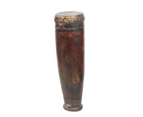 A 19TH CENTURY AFRICAN DRUM with goats skin top on a hollowed trunk wooden base 103cm high.