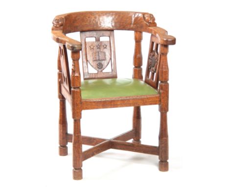 AN EARLY  ROBERT 'MOUSEMAN' THOMPSON OAK MONKS CHAIR with hooped arms and carved masks to the backrest, on octagonal-shaped s