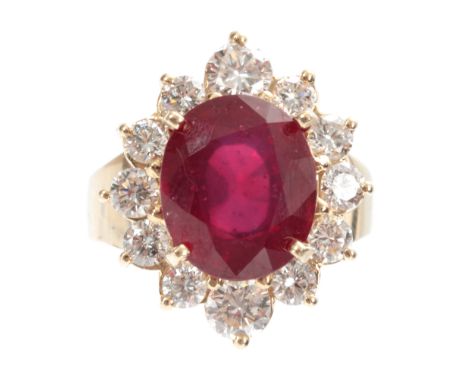 A LADIES 14ct GOLD RUBY AND DIAMOND RING having a 7ct oval brilliant-cut ruby surrounded by 12 diamonds app. 1.5ct, total wei