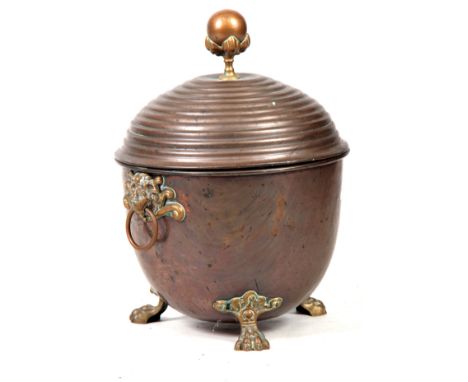 A 19TH CENTURY REGENCY COPPER AND BRASS LIDDED COAL BUCKET having looped lion mask handles, lion paw feet with domed beehive 