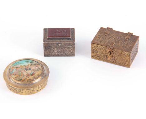 A COLLECTION OF THREE SMALL PERSIAN BOXES, a White metal engraved with a geometric pattern having a carnelian intaglio of Peg