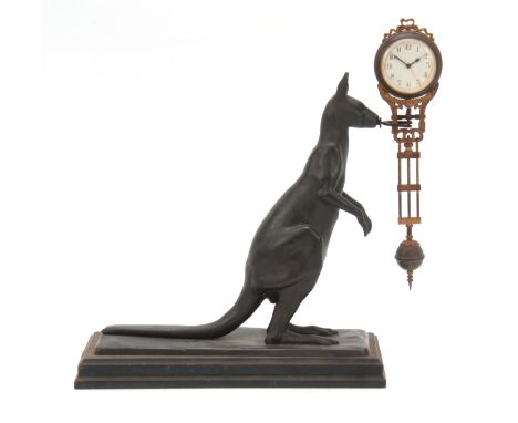 AN EARLY 20th CENTURY PATINATED METAL KANGAROO MYSTERY MANTEL CLOCK the kangaroo standing on naturalistic base holding the cl
