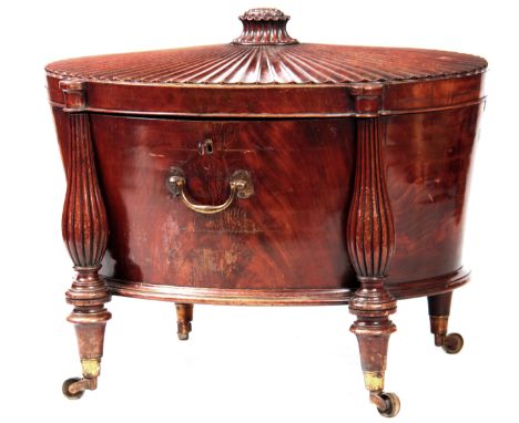 A FINE GEORGE III HEPPLEWHITE MAHOGANY OVAL CELLERETTE / WINE COOLER OF GENEROUS SIZE the slightly raised fan fluted top with
