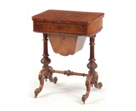 A VICTORIAN BURR WALNUT WORK / GAMES TABLE having hinged revolving top above a pull-out drawer and inlaid box; standing on ca