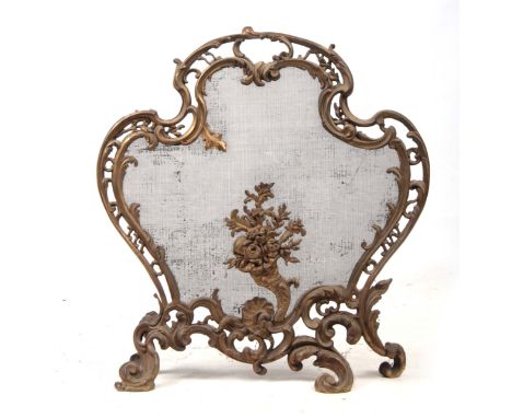 A 19TH CENTURY ORMOLU FRENCH ROCOCO STYLE FIRE SCREEN having mesh steel interior - 74cm high 69cm wide