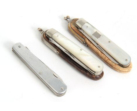 A SELECTION OF THREE EARLY 20TH CENTURY FOLDING FRUIT KNIFE AND FORKS with a split mechanism to separate the knife from the f