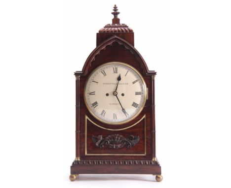 FORSYTH &amp; MALTER, LONDON A REGENCY ROSEWOOD BRACKET CLOCK having a gadrooned finial above a lancet top case with cluster 