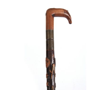 A LATE 19th CENTURY SWORD STICK the fruitwood handle with carved animals head having a brass hinged cap snuff compartment, at