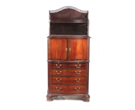 AN UNUSUAL SERPENTINE THREE TIER CABINET ON CHEST IN MANNER OF CHIPPENDALE with a two-tier fret cut super-structure above a c