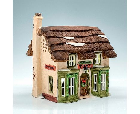 Part of the Dickens Village Series. Porcelain, depicting quaint thatched roof toy shop with light feature. This item has its 