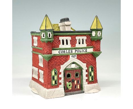 Department 56 figurine, Cobles Police Station. The figurine shows the Cobles Police Station that is made of brick and mortar 