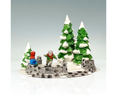 This figure shows a winter time scene with two children skating on a frozen lake around pine trees. This item has its origina