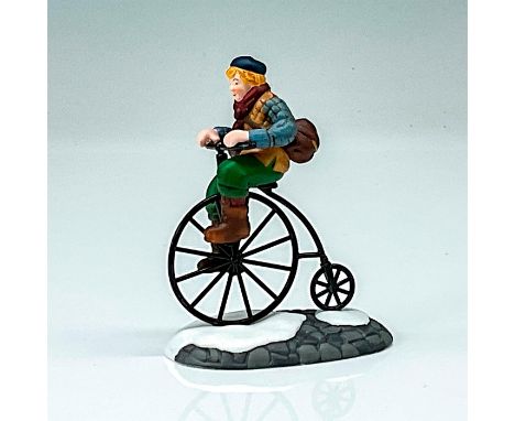 This figure has a young village man riding on his penny-farthing bicycle during winter. This item has its original box. Origi