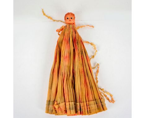 This celluloid kewpie doll was made in Japan and came with a crepe paper dress that is close to a foot long. Issued: c. 1930D