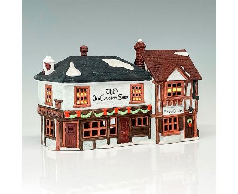Part of the Dickens' Village Series. Hand-painted porcelain figure modeled as a Victorian style storefront. Department 56 bac