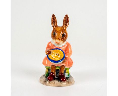 Depicts a brown bunny in a pink dress sitting down and mixing her ingredients in the bowl. Royal Doulton backstamp. Dimension