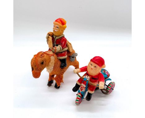 Includes: one Santa riding a reindeer and holding a sack on his back; and the second Santa riding a festive tricycle with bel