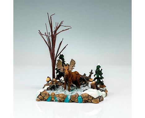 Department 56 figurine, "Moose in the Marsh". The figurine depicts a Moose standing in shallow water in a winter forest setti