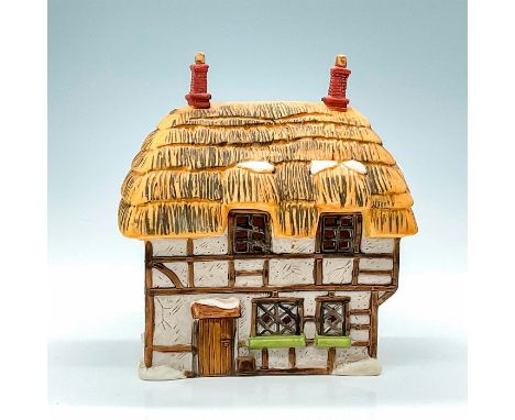 Part of the Dickens Village Series. Porcelain, depicting quaint cottage with thatched roof and light feature. This item has i
