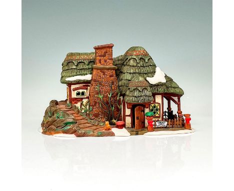 This figure shows a forest village cottage with encompassing staircase and fenced porch. This item has its original box. Dime