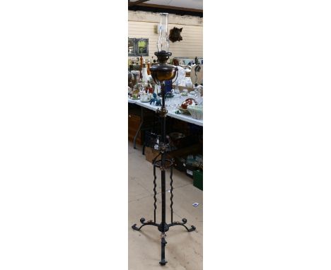 Antique wrought-iron standard lamp, with fitted oil lamp and chimney, height 156cm 