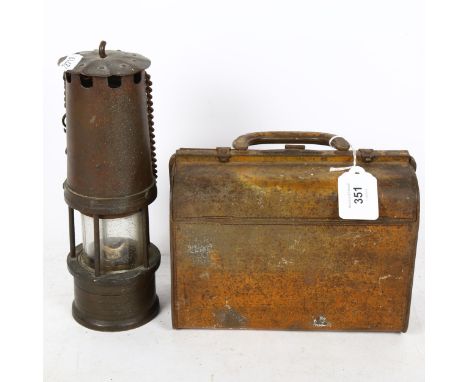 A Huntley &amp; Palmers novelty tinplate Gladstone bag biscuit tin, and a Vintage miner's oil lamp, height 24cm (2) 
