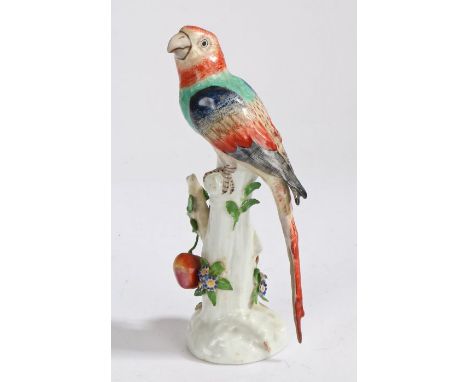 A Sampson Chelsea style porcelain parrot, the polychrome parrot standing on a branch with hanging fruits and flowers, gold an