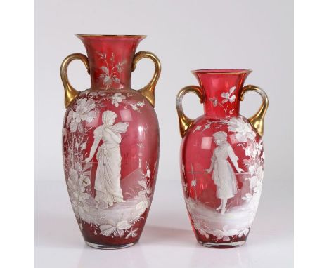 Two Bohemia glass vases, with gilt handles, the bodies decorated with white enamel in the style of Mary Gregory with young la