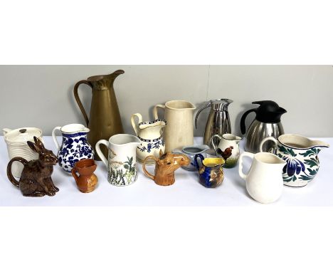 A wide assortment of jugs, including a Wemyss example, decorated with a cockerell, a jug in form of a hare, and another of ho