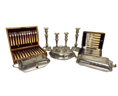 A group of silver plate, including a pair of candlesticks, a cased set of fish eaters, a covered vegetable dish and similar (