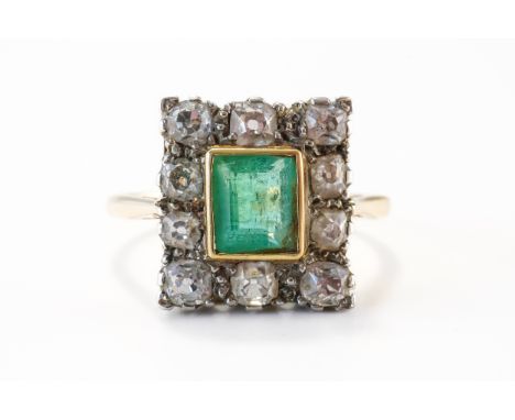 A GOLD, EMERALD AND DIAMOND CLUSTER RINGMounted with a rectangular cut emerald at the centre, within a surround of ten old cu