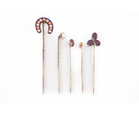 A VICTORIAN CORAL, HALF PEARL AND BLUE ENAMELLED HORSE SHOE STICKPIN AND FOUR FURTHER STICKPINS (5)The further stick pins com