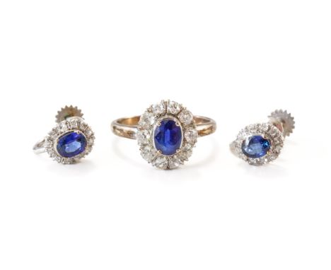 A SAPPHIRE AND DIAMOND OVAL CLUSTER RING AND A PAIR OF EARRINGS (3)The ring claw set with the oval cut sapphire in a surround
