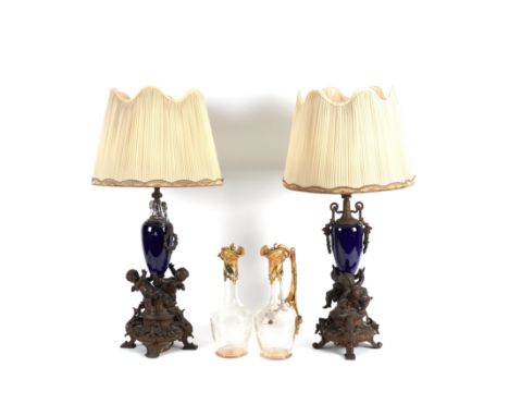 A PAIR OF BRONZE PATINATED SPELTER MOUNTED SEVRES BLUE CERAMIC TABLE LAMPS (4)Early 20th Century  Modelled with cavorting che
