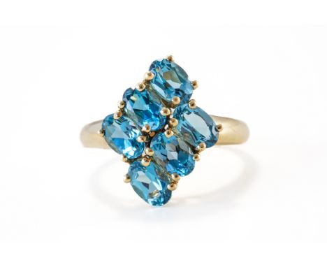 A BLUE TOPAZ RINGClaw set with six oval cut blue topaz stones, in 9ct, size R½, gross weight 3.6 grams