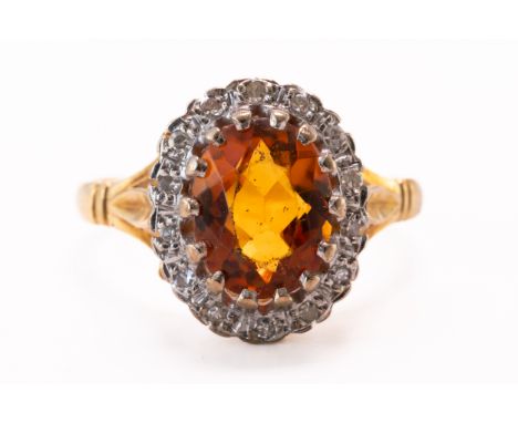 AN 18CT GOLD, CITRINE AND DIAMOND OVAL CLUSTER RINGClaw set with the oval cut citrine within a surround of circular cut diamo