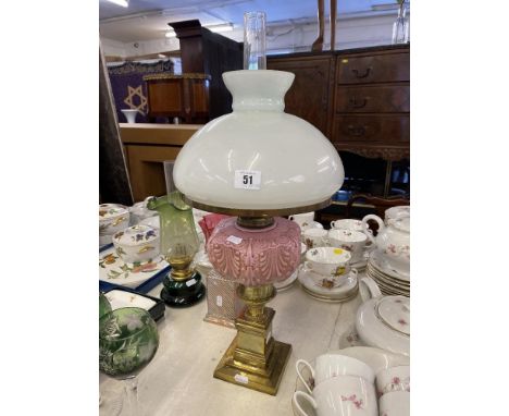 A Victorian oil lamp, brass, with pink reservoir