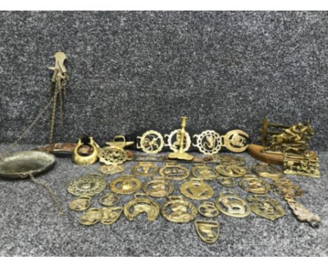 Box containing a collection of vintage brass buckles including horses cats a brass candlestick etc