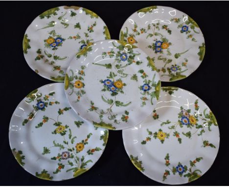A group of 5 18th century faience ware plates with floral designs and indistinct signature to rear (5).  1 damaged and other 
